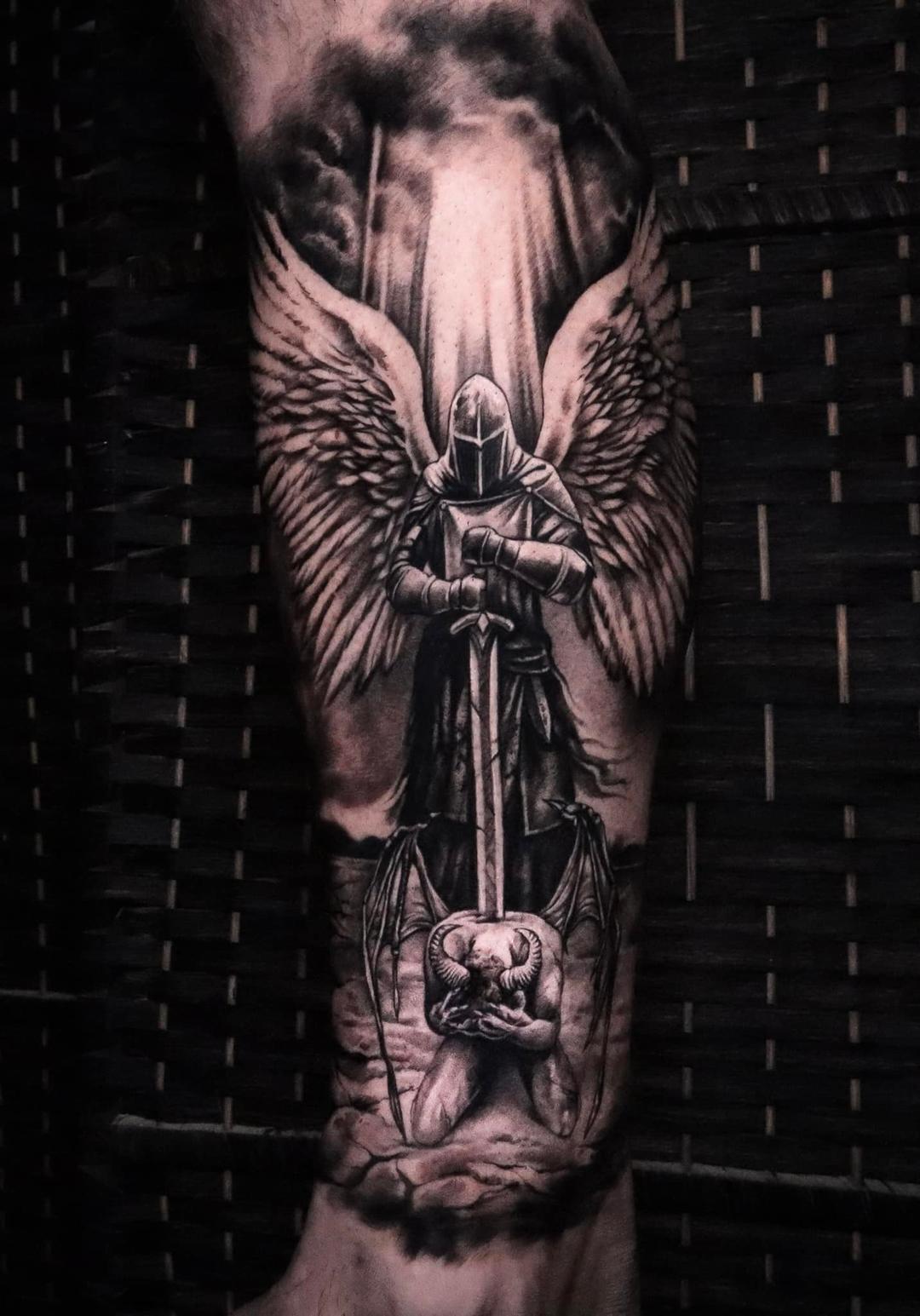 Tattoo archangel on the leg in style black & gray