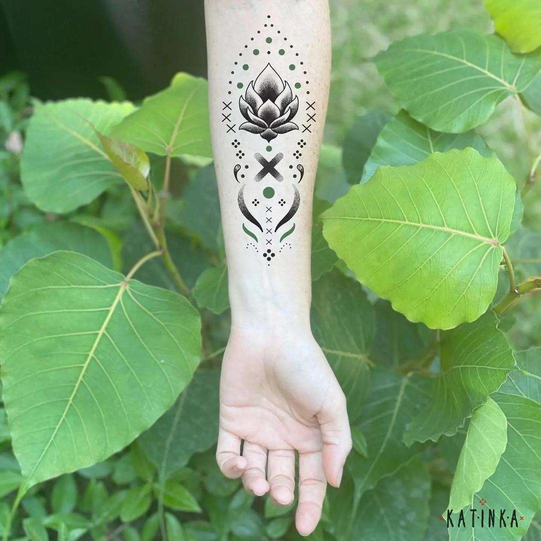 Tattoo lotus on the forearm in style oriental